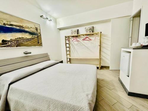 a bedroom with a bed and a painting on the wall at San Lorenzo Room in Trapani