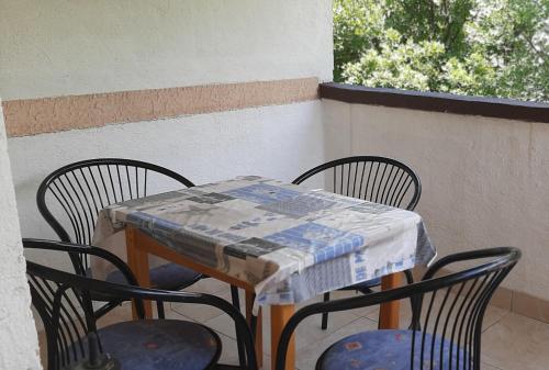 a table with two chairs and a table cloth on it at Apartments Vila Zagorje in Stinica