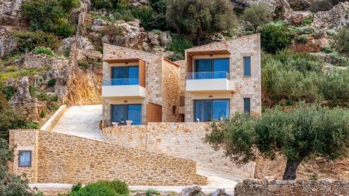 a house on the side of a mountain at Anadia Luxury Pocket Villa in Falasarna