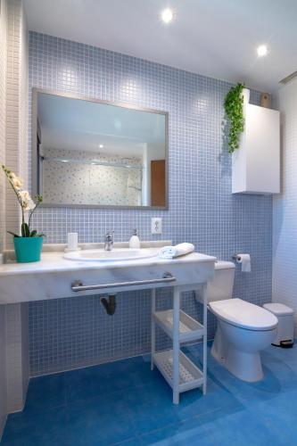 a bathroom with a sink and a toilet at Ninel Home Tenerife in Palm-Mar