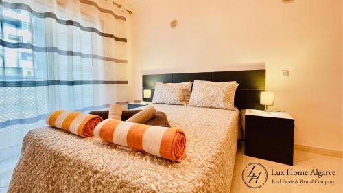 a bedroom with a bed with a large window at Alegria - Shopping Center 150m - Pool - Parking - Terrace in Portimão