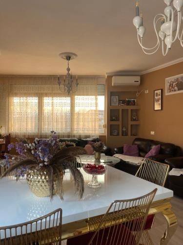 a living room with a white table with chairs at Besa Apartment in Tirana