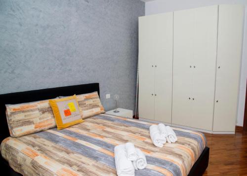 a bedroom with a bed with white slippers on it at LA CASA DI AMBRA in Limbiate