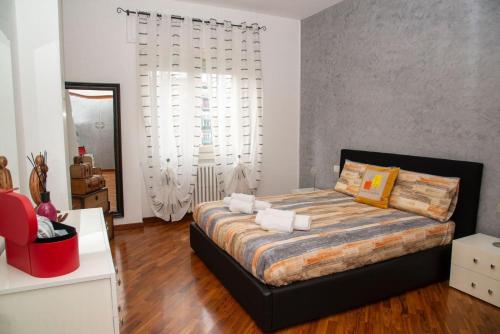 a bedroom with a large bed in a room at LA CASA DI AMBRA in Limbiate