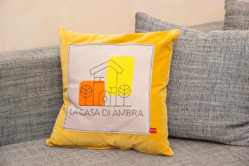 a yellow pillow sitting on a couch at LA CASA DI AMBRA in Limbiate