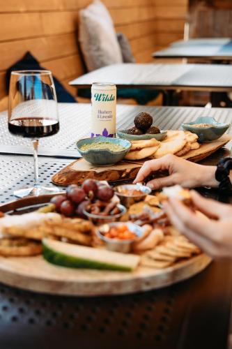 a table with a plate of food and a glass of wine at Penny's Motel in Thornbury
