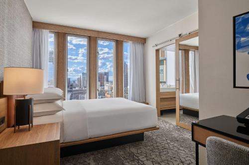 a hotel room with a bed and a large window at Sheraton Denver Downtown Hotel in Denver