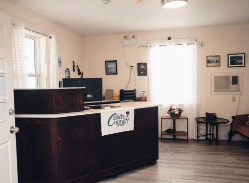 a room with a counter with a sign on it at Ceilidh Country Lodge in Baddeck