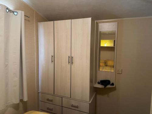 a white cabinet in a room with a sink at CaSa VistA - Holiday Home On The Beach in Clacton-on-Sea