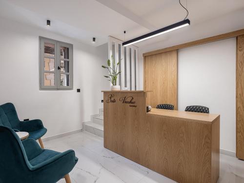 a waiting room with two chairs and a reception desk at Porto Vecchio in Chania