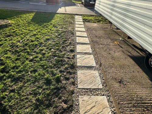 a stone walkway next to a house at CaSa VistA - Holiday Home On The Beach in Clacton-on-Sea