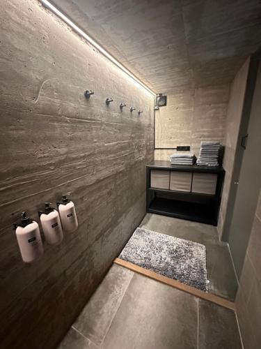 a bathroom with three rolls of toilet paper on the wall at Sogavegur 50 in Reykjavík