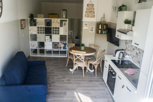 a kitchen and dining room with a table and chairs at ANCORA...IO E TE in Focene