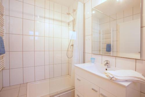 a white bathroom with a sink and a shower at Casa Progreso Costabella in Marbella