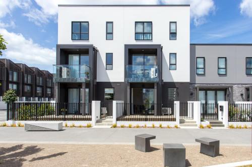 a white building with a balcony on a street at Location Location Location 2 Mins CBD Free Parking in Christchurch