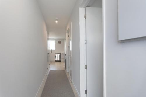 a hallway with white walls and a white hallway with a hallway at Location Location Location 2 Mins CBD Free Parking in Christchurch