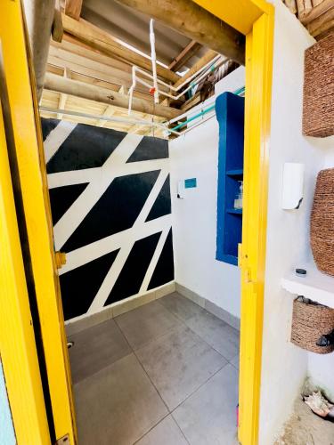 a room with a garage door and a yellow doorway at Hostel Santa Cruz del Islote in Santa Cruz del Islote