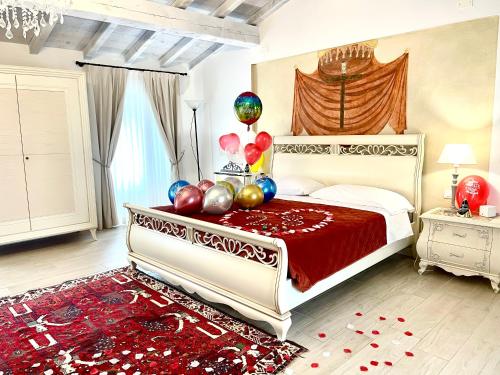 a bedroom with a bed with balloons on it at Dimora di Charme Rooms & Apartments in Peschiera del Garda