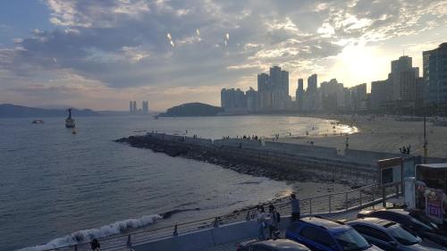 a view of a beach with a city and the ocean at Haeundae Mipo House22 in Busan