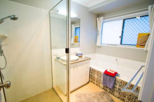 a bathroom with a shower and a sink at Seas The Day - Pet-friendly house in Agnes Water in Agnes Water