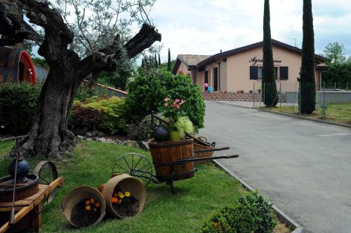 a wheelbarrow with flowers in it next to a street at La Corte D'Emilio B&B in Vignola