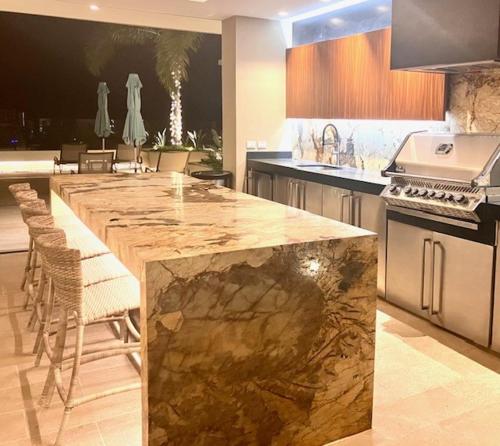 a kitchen with a large marble island in a kitchen at Casa Cielo Vallarta V-Golf in Puerto Vallarta