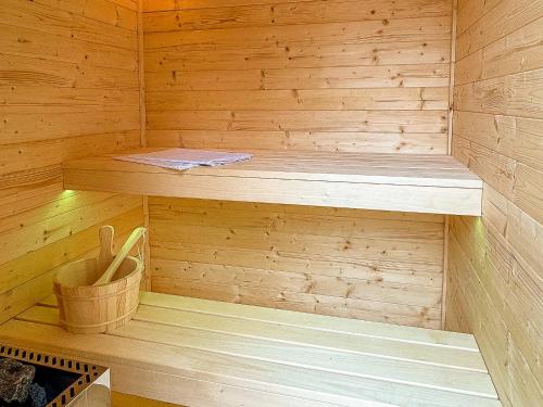 a wooden sauna with a wooden bench in it at Chillout Apartman Noszvaj in Noszvaj