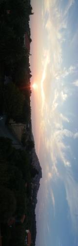 a view of the sun setting on a mountain at Eleni Studios & Apartments in Mithymna