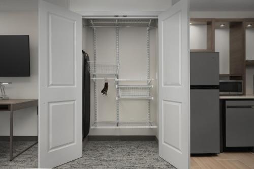 a kitchen with white doors and a refrigerator at TownePlace Suites by Marriott Abilene Southwest in Abilene
