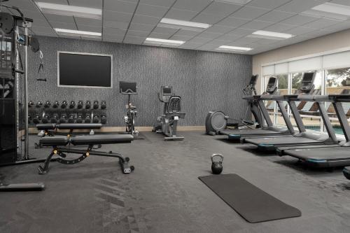 a gym with several tread machines and a tv at TownePlace Suites by Marriott Abilene Southwest in Abilene