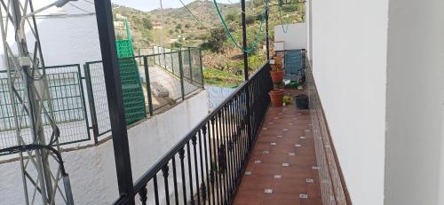 a balcony with a fence and a view of a mountain at piso en arenas de velez malaga in Málaga