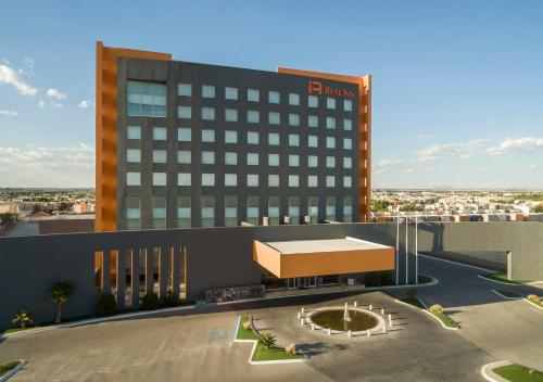 a rendering of a hotel with a building at Real Inn Ciudad Juarez by the USA Consulate in Ciudad Juárez