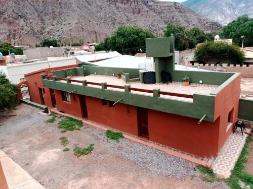 an overhead view of a building with mountains in the background at Ipay Alojamiento Familiar in Purmamarca