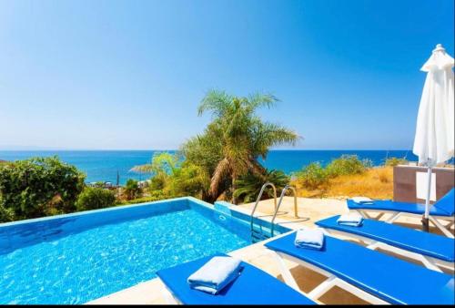 a swimming pool with a view of the ocean at Mermaid Villa in Pomos