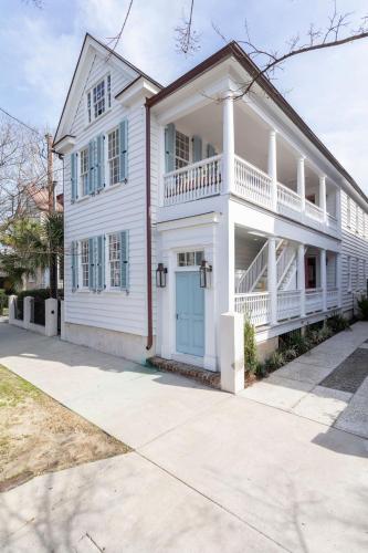 a white house with a blue door at Royal Cottage I in Charleston