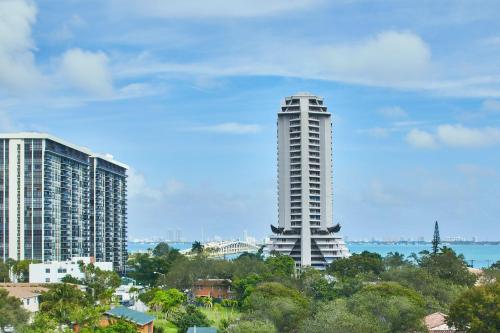 a tall white building in front of some buildings at AC Hotel Miami Wynwood in Miami