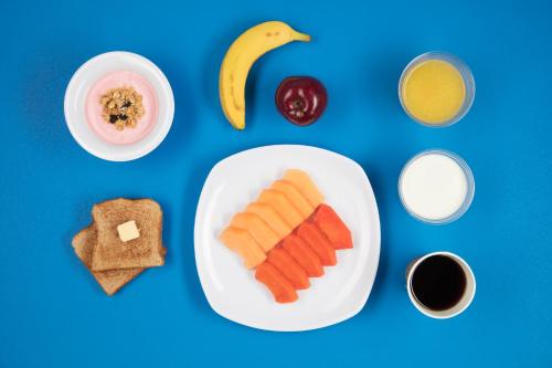 a table with a plate of food with breakfast foods at One Mexicali in Mexicali