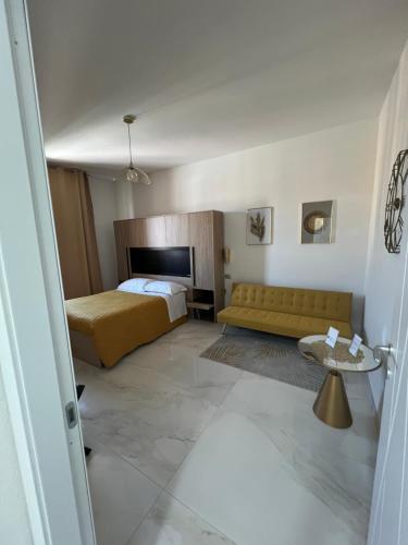 a hotel room with a bed and a couch at Lupo Luxury Rooms in Bologna
