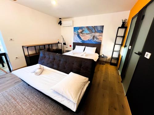 two beds in a room with a couch at Zoela in Izola