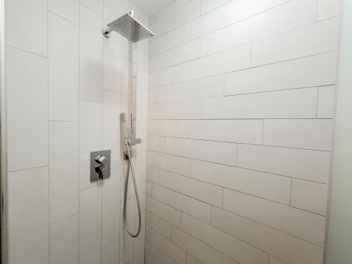 a bathroom with a shower with white tiles at Zoela in Izola