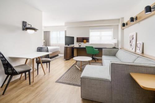 a living room with a couch and a table at Residence Inn by Marriott Miami Aventura Mall in Aventura