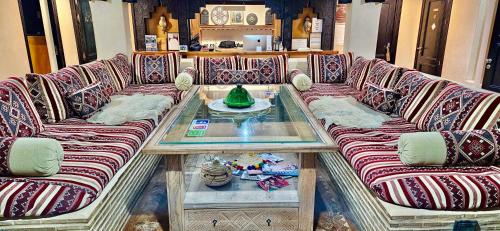 a living room with couches and a coffee table at Riad Dar Haven in Tamraght Ou Fella