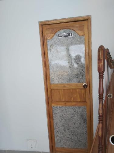 a wooden door with a glass window in a room at Dreimar Hotel Boutique in Cartagena de Indias