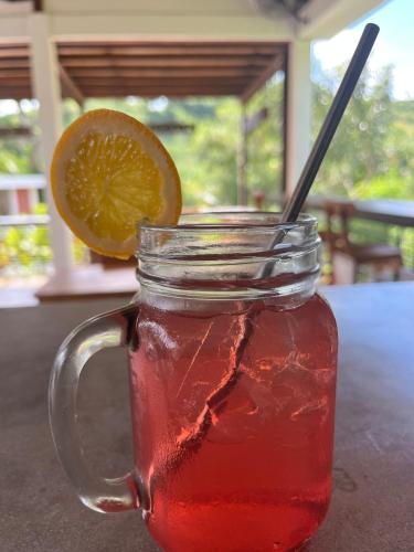 a mason jar filled with a drink with a lemon slice at The Local Are Guling in Kuta Lombok