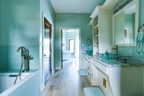 a bathroom with two sinks and a tub at Luxury Villa, Perfect for Groups. Stunning Pool. Allamanda del Mar in Placencia Village