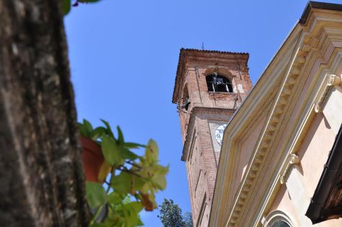a tall tower with a clock on a building at Palazzo Tornielli in Mombello Monferrato