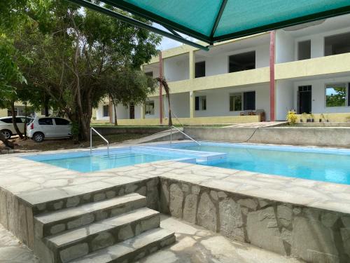 einem Pool vor einem Gebäude in der Unterkunft Jade luxury apartments Diani in Mombasa