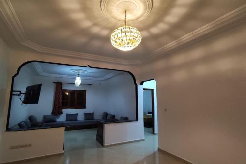 a large mirror in a living room with a couch at Warzazat Apartments in Ouarzazate