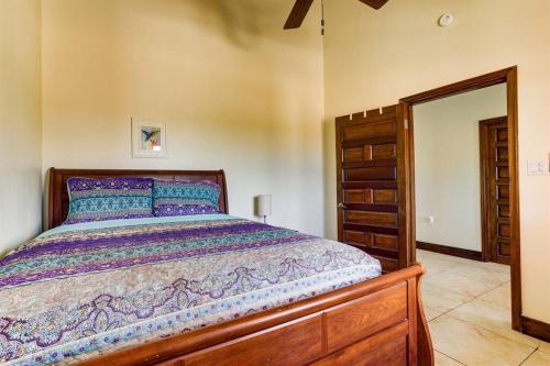 a bedroom with a wooden bed and a dresser at Casa Valencia - Modern Pool Family Luxury Sleeps 8 in Placencia Village