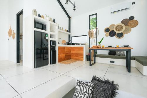 a living room with a table and a couch at Villa Neptune Uluwatu in Uluwatu